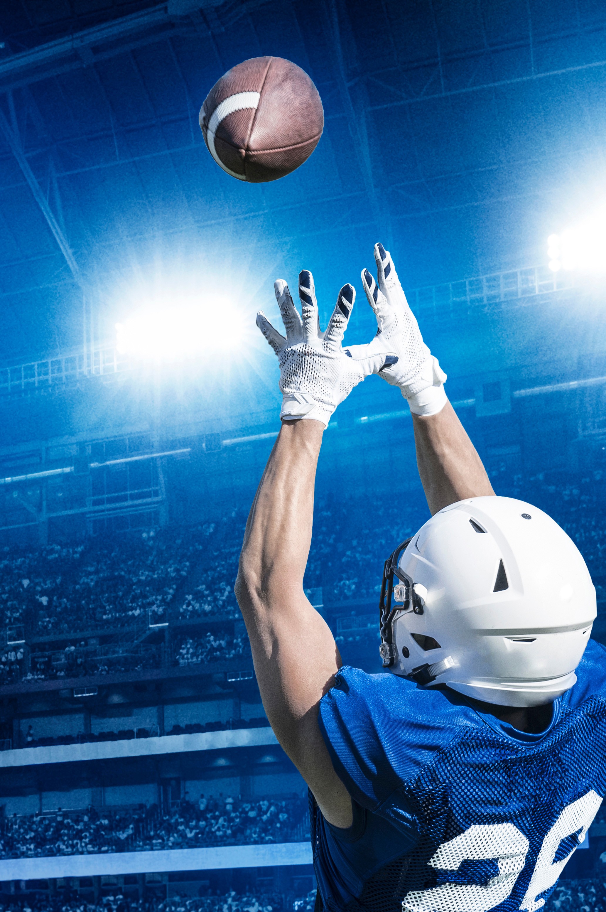 Photo of a silhouette of 2 dancers posing in front of a red curtain.